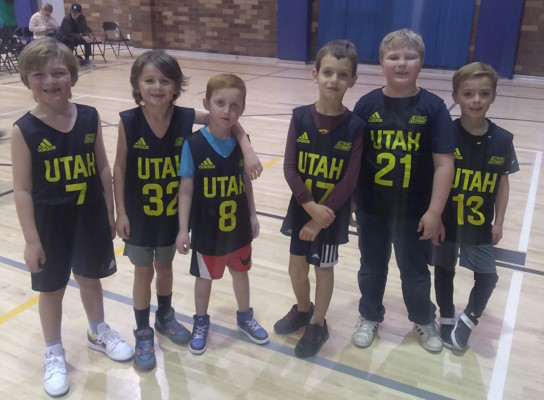 Six boys posing for a team photo in Jazz jerseys